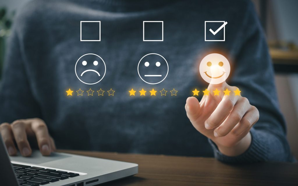 Finger pointing at a smiley face rating