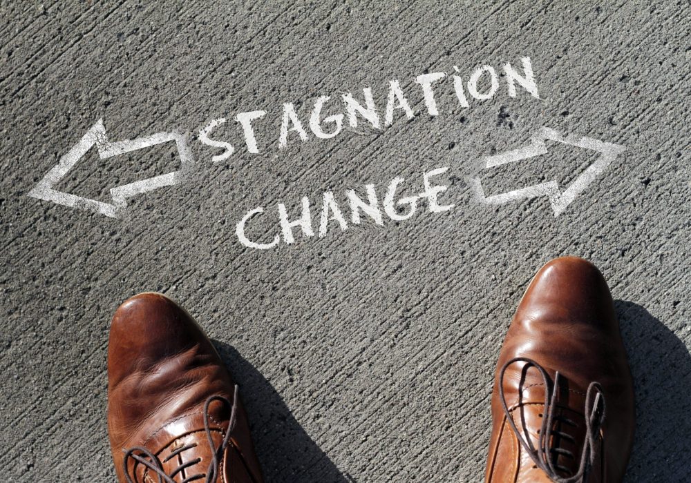 Shoes on pavement at a crossroads between stagnation and change